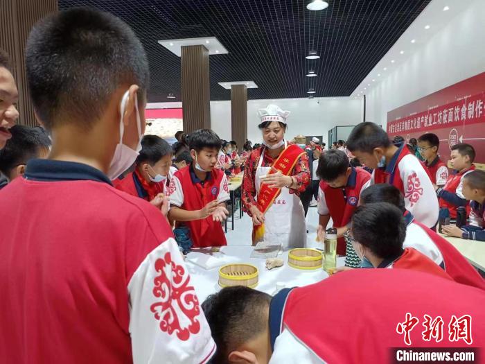 图为王改玲(左三)在教学子们制作莜面。 王改玲供图